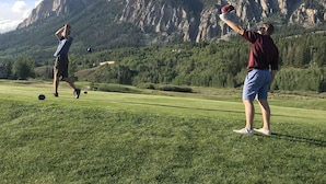 A golf course with a mountainous backdrop. - Spacious ski in double condo prime base area location by Mountaineer Square.   (Mt. Crested Butte)