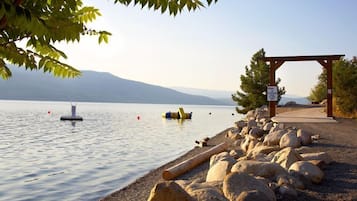 Enjoy serene views of the lake and distant mountains from this lakeside retreat.