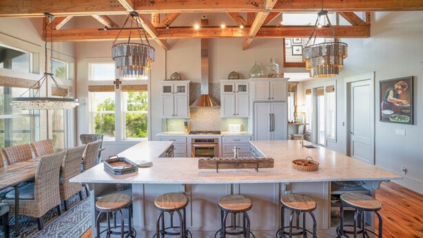 A spacious kitchen with a large island, wooden beams, and pendant lighting. - 'Forcynthia' Luxury Bay Home 4BR/4.5BA ,w/ dock, kayak launch (St. George Island)