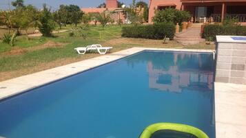 Outdoor pool, open 10:30 AM to 7:00 PM, pool loungers