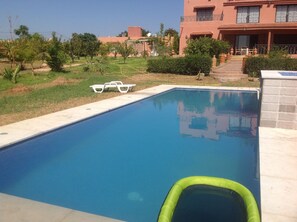 Outdoor pool, open 10:30 AM to 7:00 PM, pool loungers