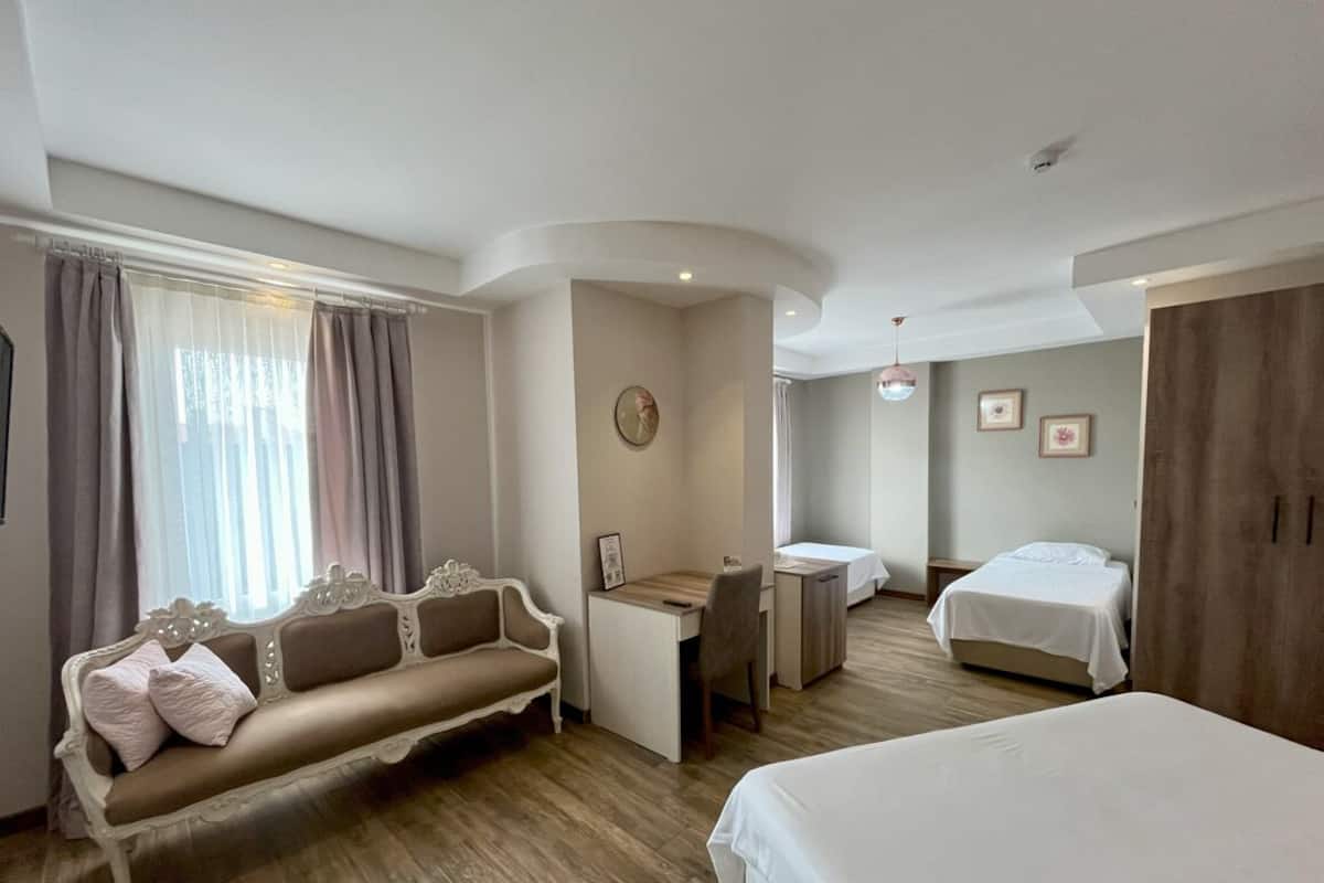 Standard Quadruple Room, Multiple Beds, Non Smoking | Minibar, desk, laptop workspace, iron/ironing board