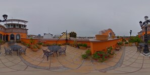 A rooftop patio with outdoor seating, potted plants, and a sign for 'La Marquise Hotel'. - Hotel Hacienda Los Narcisos (San Juan de los Lagos)