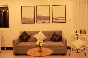 Relax in this inviting living area with a sofa, coffee table, and comfortable seating for two.