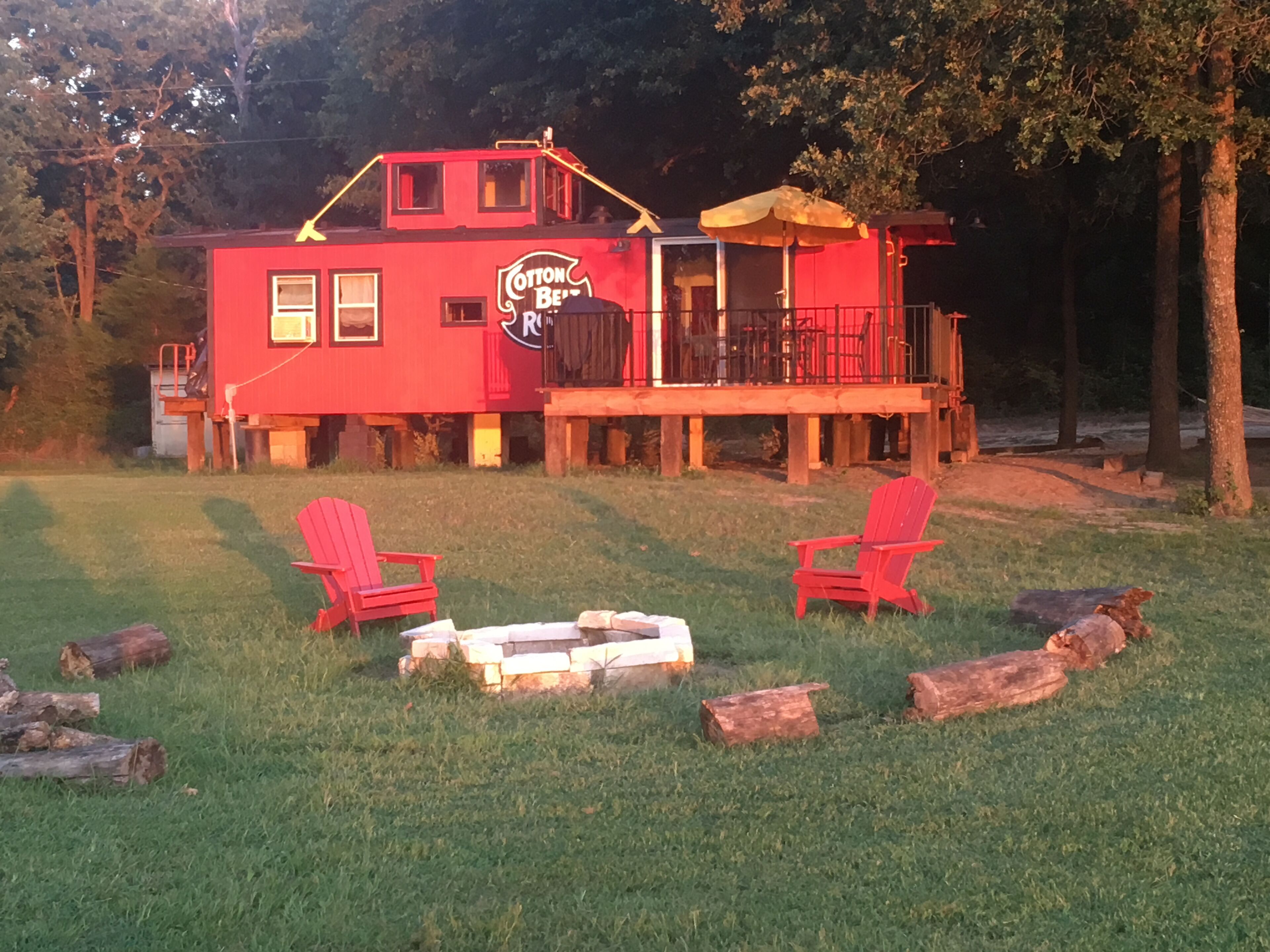 A red building with a sign reading "Cotton Bee's" and a deck with chairs.