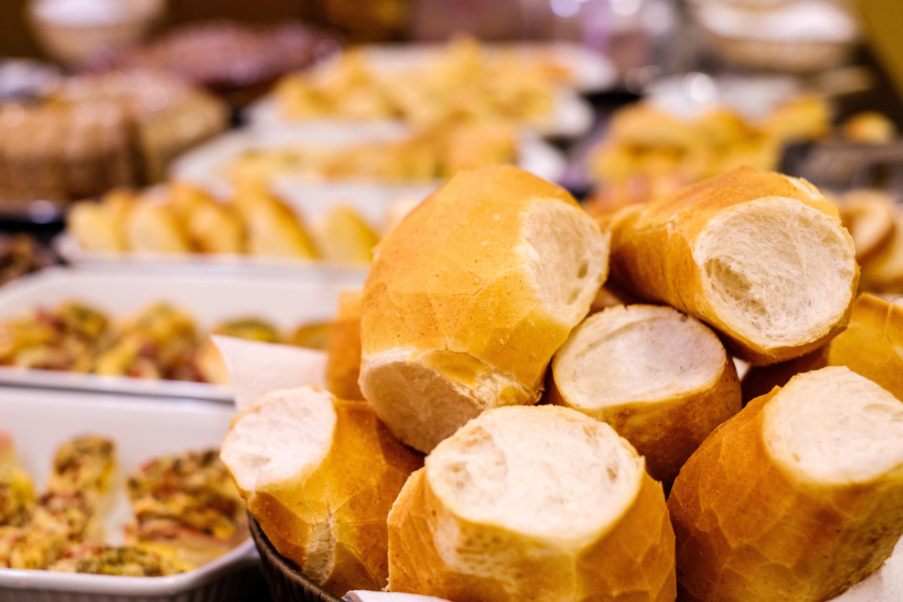 A display of various bread rolls and pastries, likely in a bakery or catering setting.