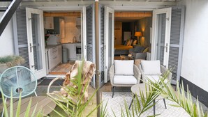 An open patio with a dining area, a kitchen, and a living room.