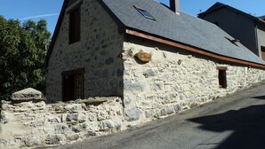 A stone building with a sloped roof, a chimney, and a small window. - Authentic sheepfold renovated  (Sazos)