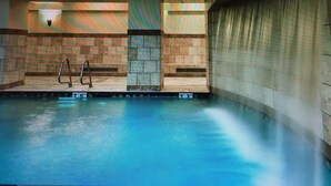 A swimming pool with a diving board, tiled walls, and a window. - 1 Bedroom Luxury Villa Ski in/Ski out Park City Westgate Canyons Resort (Park City)