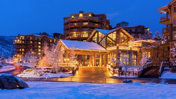A multi-story hotel with a prominent entrance, snow-covered trees, and a well-lit exterior. - 1 Bedroom Luxury Villa Ski in/Ski out Park City Westgate Canyons Resort (Park City)