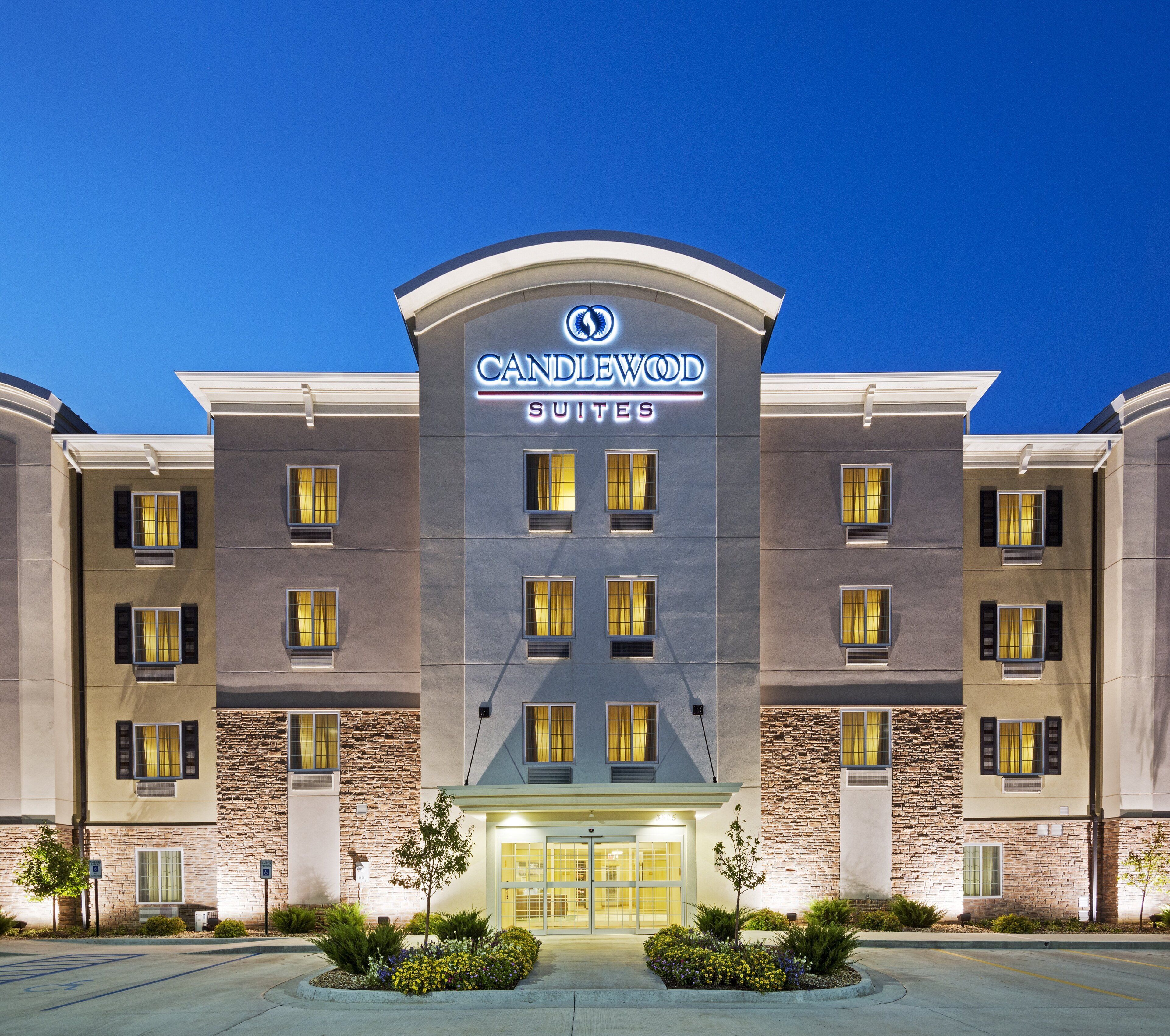 A hotel with a modern facade, multiple windows, and a prominent entrance.