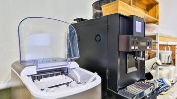 A coffee machine with a digital display and a water dispenser.