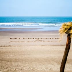 Na praia, espreguiçadeiras, guarda-sóis, toalhas de praia