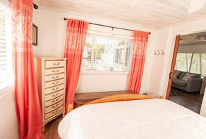 A bedroom with a bed, a dresser, and a window with curtains. - Super comfy cottage, close to the beach (Nokomis)