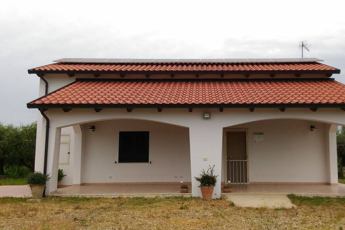 A small, single-story building with a tiled roof and a flat facade. It has a central entrance with a door and a window on the left side.