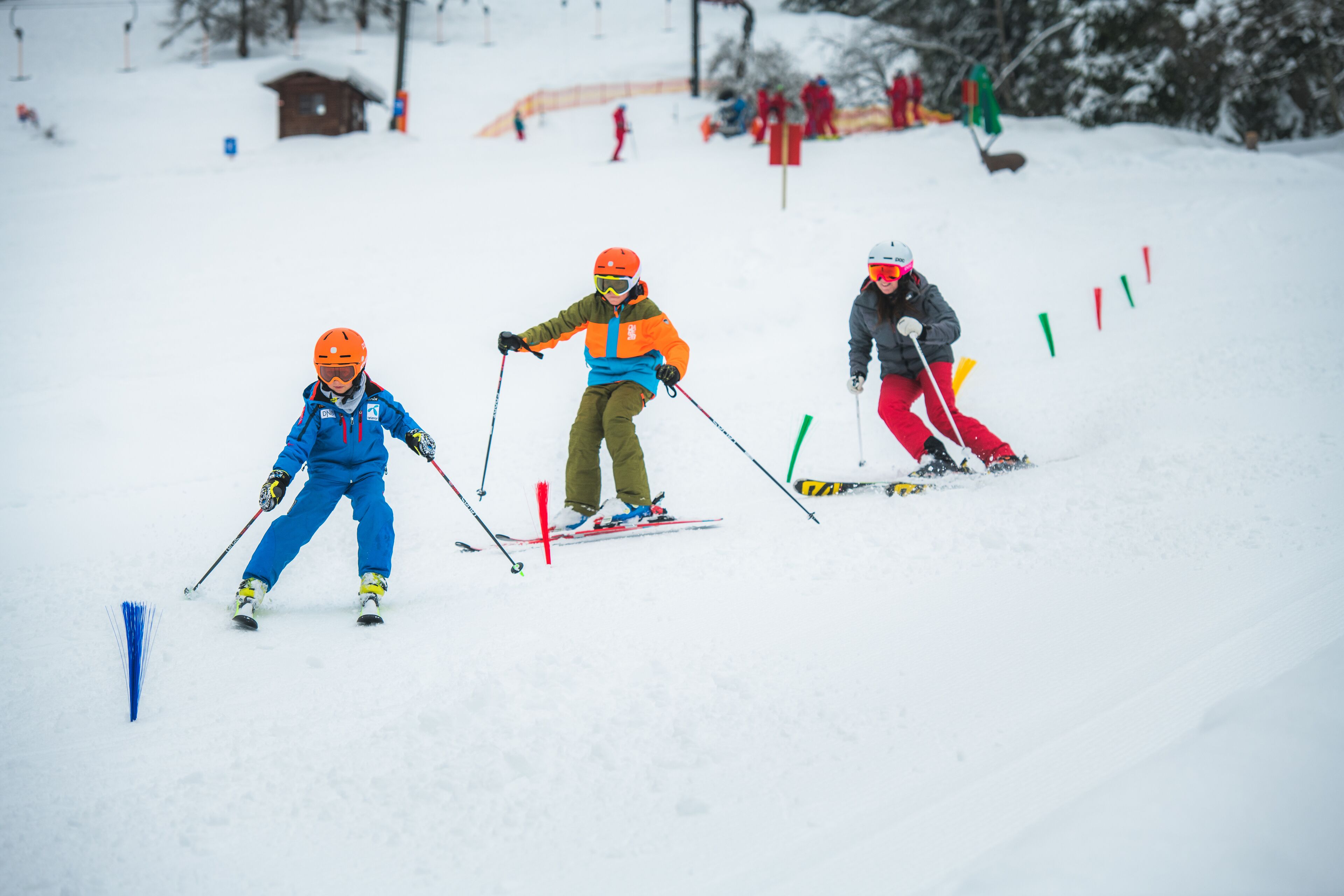 A snowy ski slope with skiers.