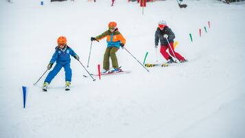 A snowy ski slope with skiers.