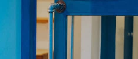 A blue metal gate with a keyhole and a lock.