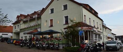 A building with a ground-floor bar and several parked motorcycles.