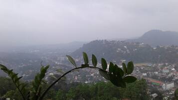 A view of a mountainous landscape with buildings scattered across the hills.