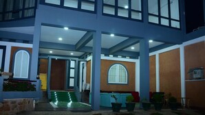 A two-story building with a covered outdoor area, a staircase, and potted plants. - Lawan One Kandy (Kandy)