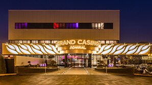 The exterior of the Grand Casino Admiral building with a modern design, featuring a prominent marquee sign and a well-lit entrance. - Admiral Hotel (Zagreb)