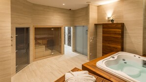 A modern bathroom with a wooden vanity, a bathtub, and a glass-enclosed shower area. - Admiral Hotel (Zagreb)