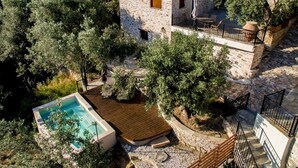 A stone house with a pool, surrounded by trees and a stone staircase. - Villas by Pelion Esties in Ano Gatzea (South Pelion)