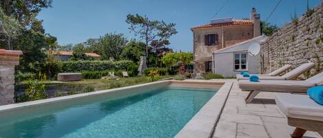 Outdoor pool, a heated pool, pool umbrellas, sun loungers