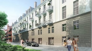 A multi-story building with a row of balconies, a paved street, and pedestrians. - Absyntapart Bulwar Staromiejski (Wroclaw)