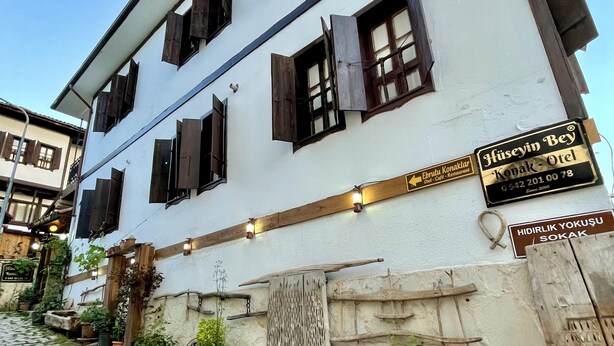A traditional building with multiple windows and a sign indicating it is a restaurant. - Huseyin Bey Konagi (Safranbolu)