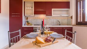 Apartment, 1 Bedroom | Private kitchen | Full-size fridge, oven, stovetop, cookware/dishes/utensils