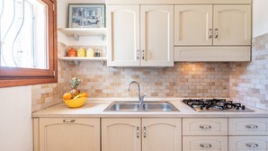 Apartment, 2 Bedrooms | Private kitchen | Full-sized fridge, stovetop, dishwasher, cookware/dishes/utensils - AffittaSardegna - Casa Dalia (Loiri Porto San Paolo)