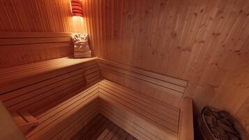 A wooden sauna with benches and a bench with a towel.