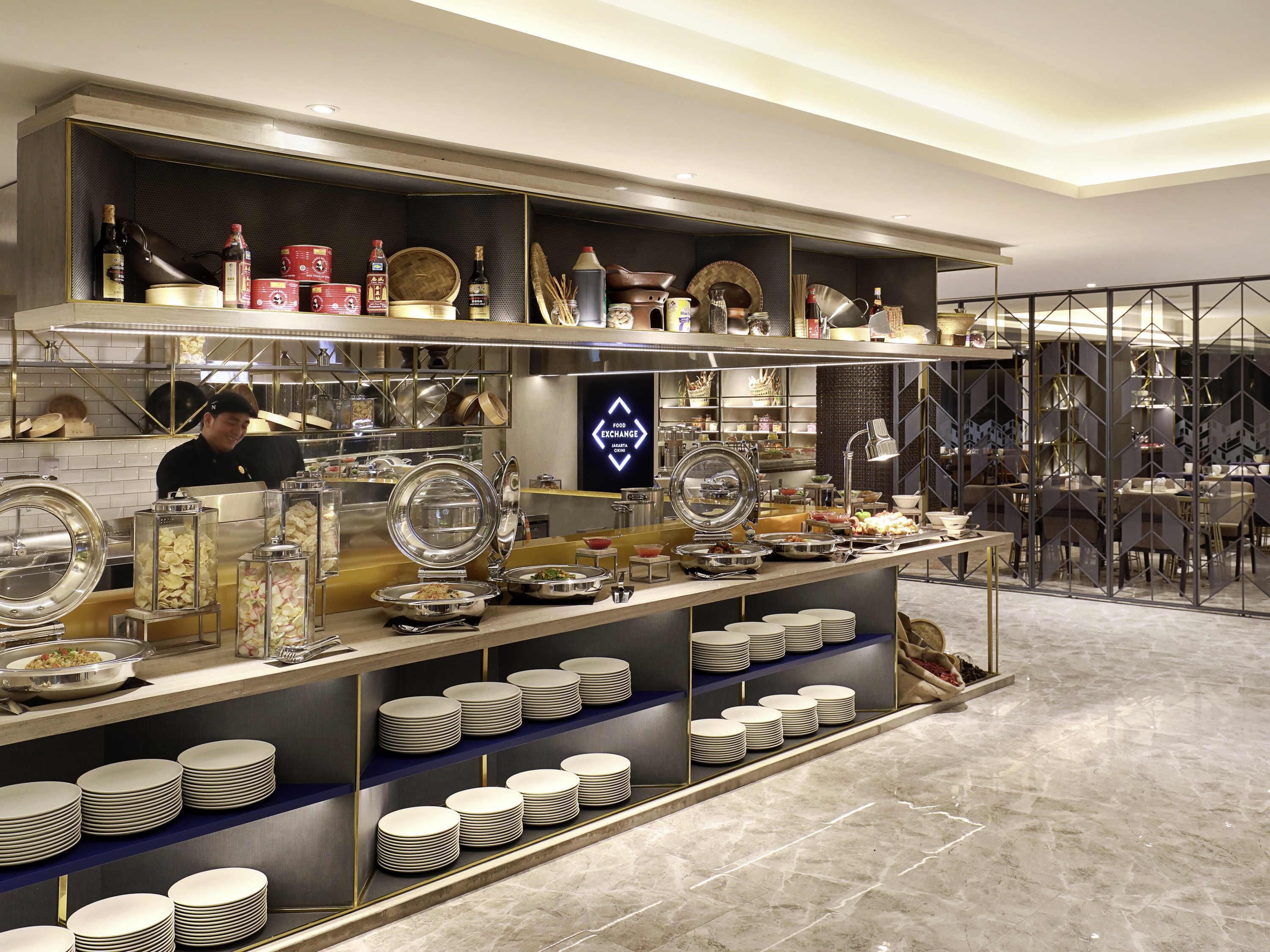 A buffet setup with various food items and utensils.