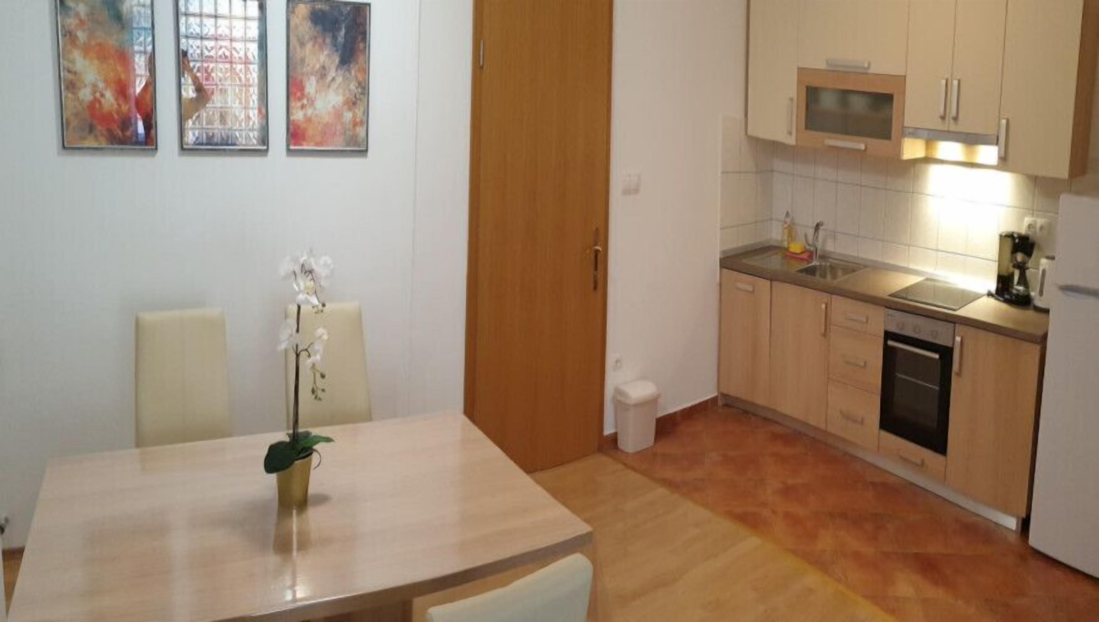 A compact kitchen with wooden cabinets, a microwave, and a coffee maker.