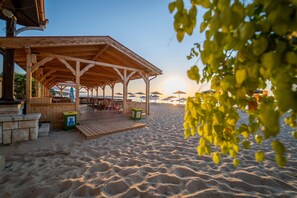 A beachside wooden pavilion with seating and a bar area, overlooking the beach. - HVD Viva Club Hotel - Ultra All Inclusive (Golden Sands)