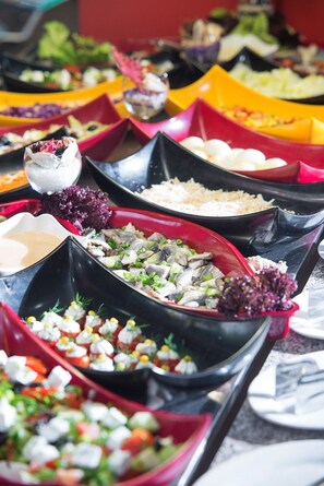 A buffet with various dishes in black and red containers. - HVD Viva Club Hotel - Ultra All Inclusive (Golden Sands)