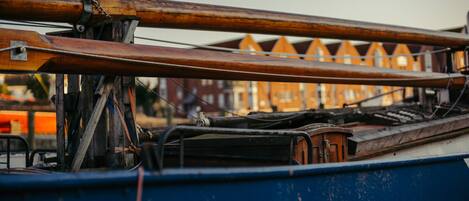 A close-up of a boat's wooden structure and metal components.
