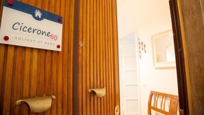 A wooden door with a sign reading "Cicerone60 Holiday at Home." - Cicerone 60 (Rome)
