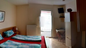 A hotel room with a bed, a desk, a chair, and a radiator. - Albergo Restaurante Da Franco (Buechenbeuren)