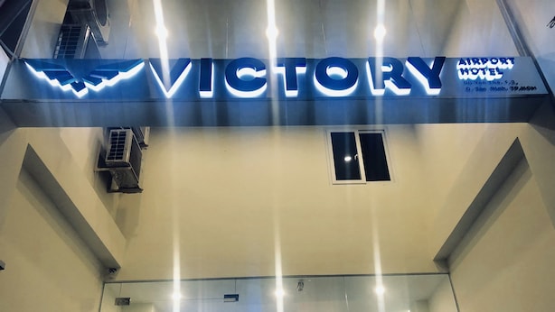 The entrance of the Victory Airport Hotel with a prominent sign and modern lighting. - Victory Airport Hotel (Ho Chi Minh City)