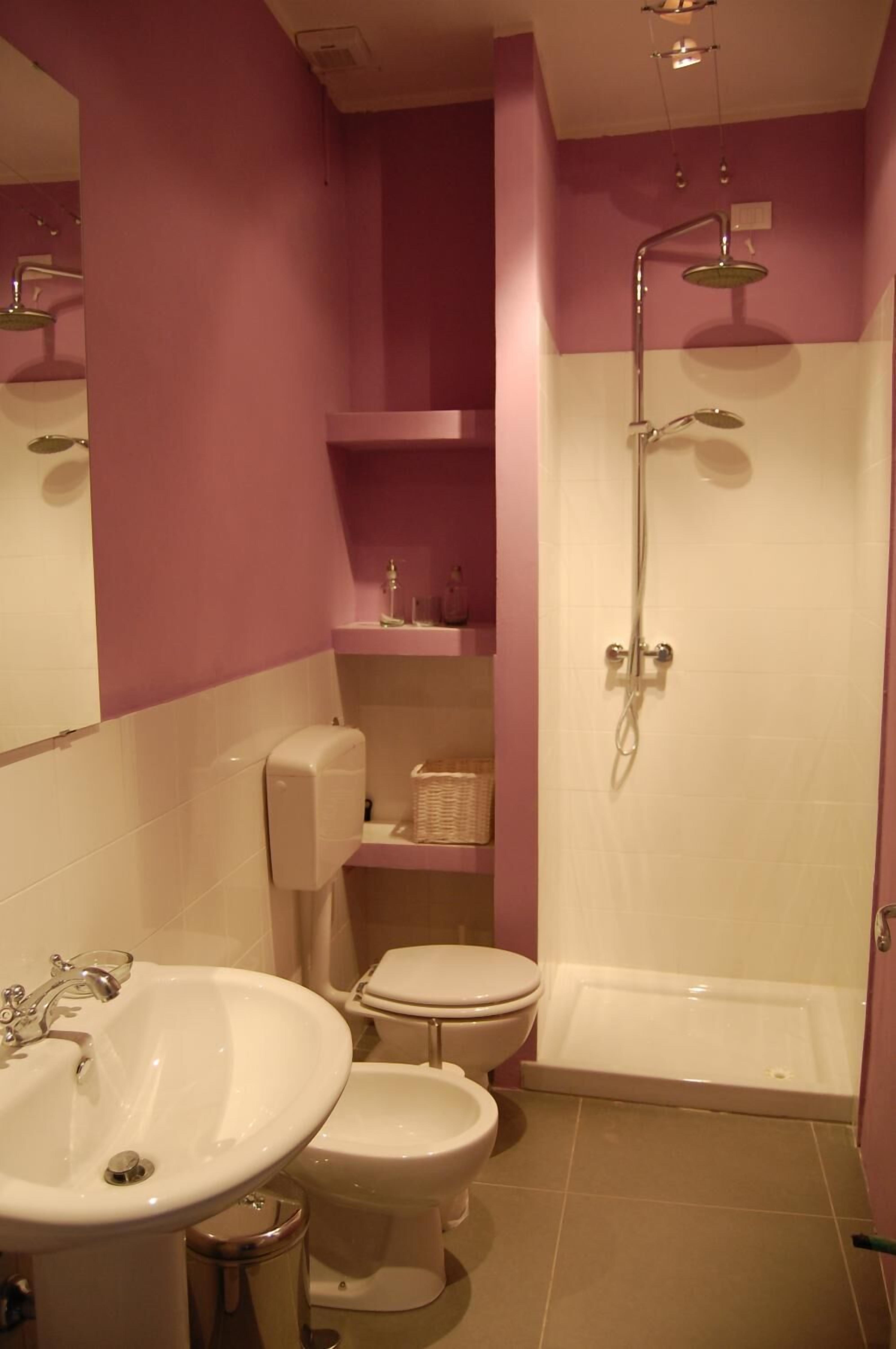 A bathroom with a sink, toilet, and shower.