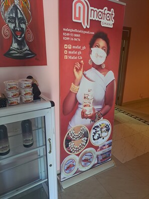 A promotional display for Mafat Shea products, including jars and a branded poster. - Dreamers Lodge (Prampram)