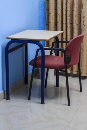 A small room with a single table and a chair. - Dreamers Lodge (Prampram)