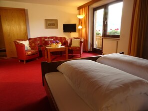 Quadruple Room, Private Bathroom | Living area | Flat-screen TV