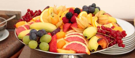 A fruit platter on a metal stand.