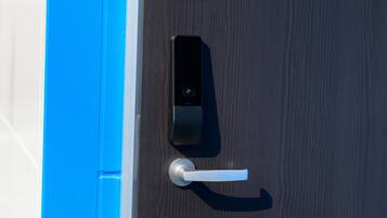 A modern door with a digital lock and a keyhole.