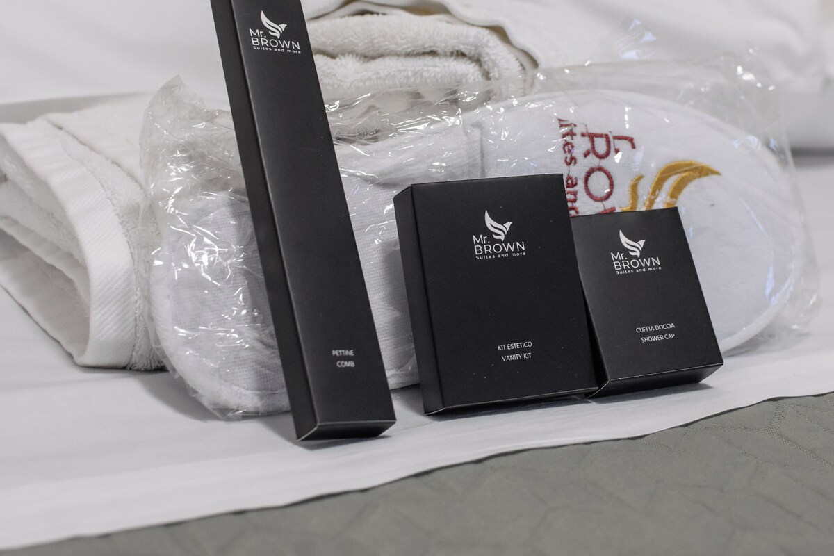 A neatly arranged set of toiletries and a towel on a bed.