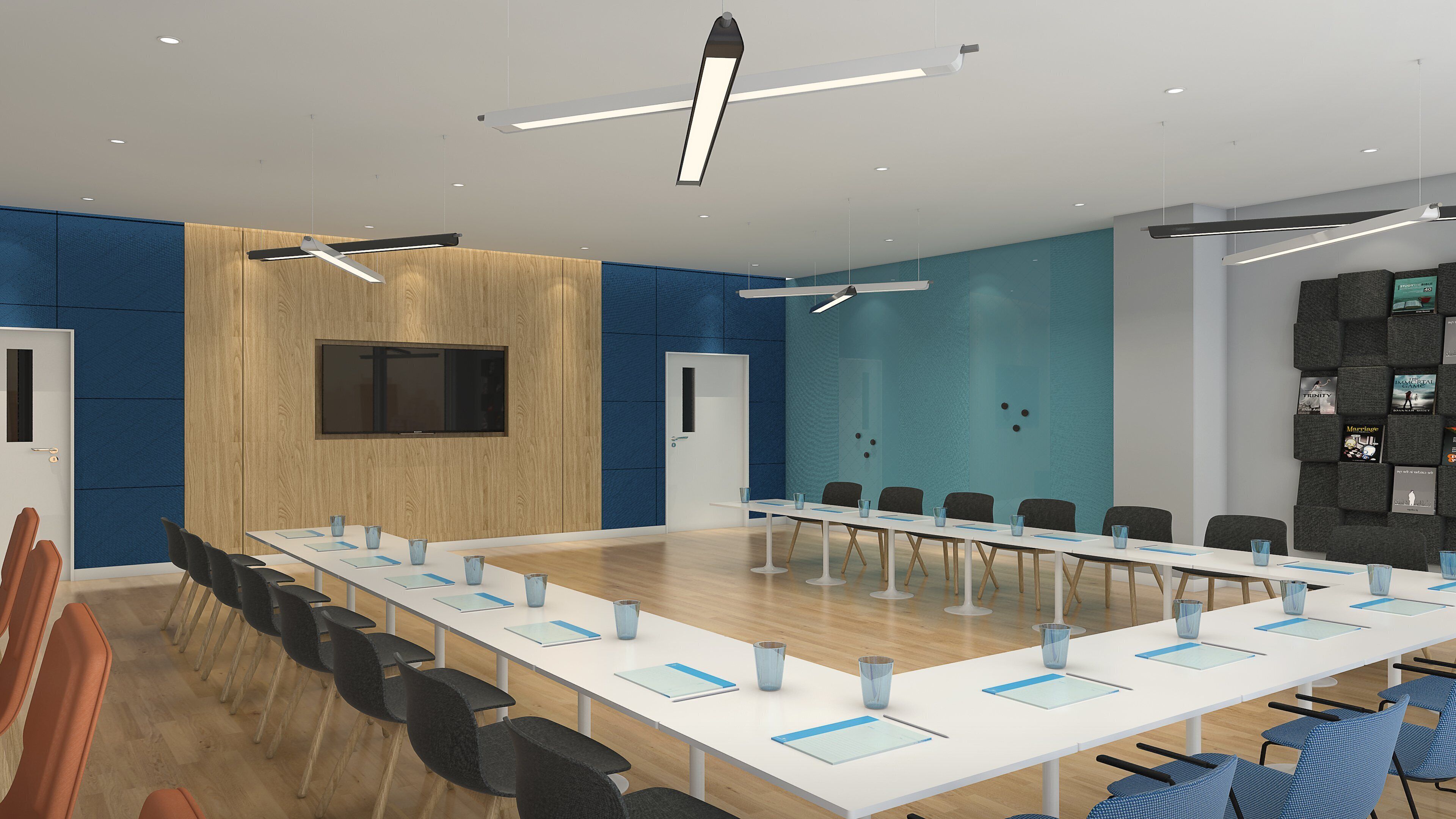 A conference room with a long table, chairs, and a TV screen on the wall.